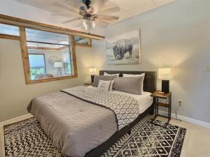 a bedroom with a large bed and a ceiling fan at The Maples w/ King Bed in Ellicottville