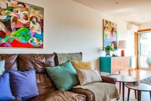 a living room with a couch and a painting on the wall at Charming Bonfim Penthouse in Porto