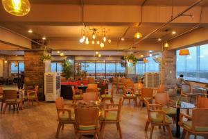 a restaurant with tables and chairs in a room at Cuu Long Hotel in Mỹ Tho