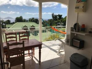 a view of a balcony with a table and chairs at Le repaire des Caraïbes in Trois-Rivières