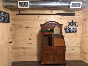 a wooden wall with a clock and a sign on it at Samantha's Timber Inn in Murfreesboro