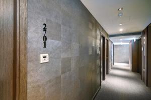 a hallway of an office with a wall with a toothbrush on it at Hotel Ease Mong Kok in Hong Kong
