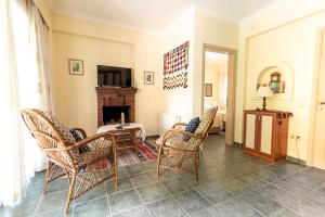 a living room with chairs and a table and a fireplace at Villa Yasemin Aparts in Göcek
