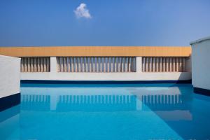 a building with a pool of water in front of it at Click&Flat Luxury Tetuan in Barcelona