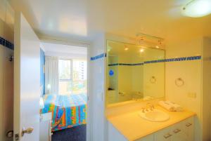 a bathroom with a sink, toilet and bathtub at Surfers Beachside Holiday Apartments in Gold Coast