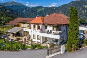 an aerial view of a house with mountains in the background at Appartements Am Burgsee in Ladis