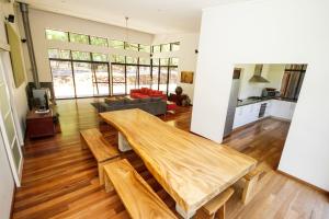 a kitchen and living room with a wooden table at Shady Glen in Prevelly
