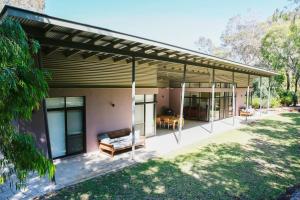 a modern house with a patio with a roof at Shady Glen in Prevelly