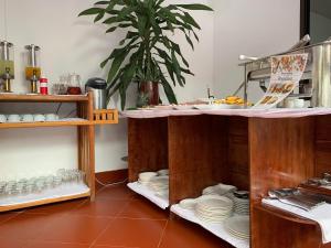 a kitchen with a counter with plates and dishes at Jasmine Vangvieng Hotel in Vang Vieng
