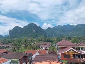 a view of a village with mountains in the background at Jasmine Vangvieng Hotel in Vang Vieng