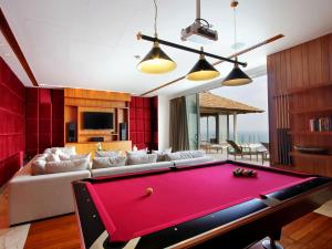 a living room with a red pool table at Villa Minh in Kamala Beach