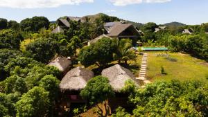an aerial view of a resort with thatched roofs at JJ ET EUPHRASIE Lodge in Nosy Be