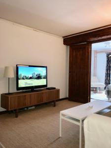 a living room with a flat screen tv on a table at Magasin 4 in Gävle