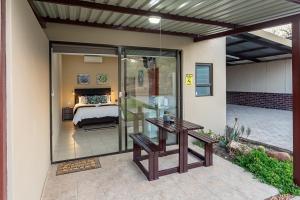 a patio with a glass door leading to a bedroom at Kiyala Guest Farm in Nelspruit
