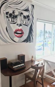a painting of a woman with sunglasses on a table at Beach Front Beauty in Melbourne
