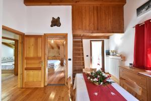 a living room with a table and a bedroom at La Casa Della Guida in Pontey +11 photos