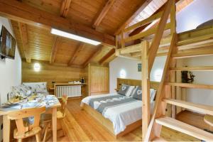 a bedroom with a loft bed and a dining table at La Casa Della Guida in Pontey