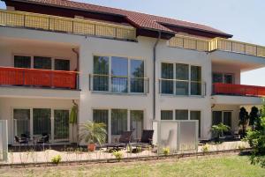 a large white house with patio furniture on it at Am Schloonsee Haus D in Heringsdorf