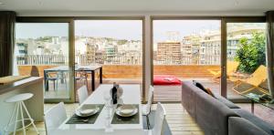 a living room with a couch and a table at Apartamentos Alfonso X in Alicante