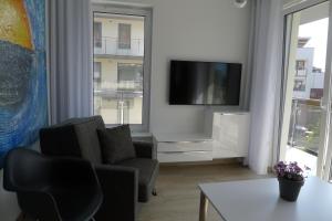 Telewizja i/lub zestaw kina domowego w obiekcie Impresja 42 Apartament z garażem