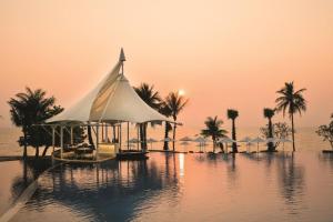 vista su un resort con piscina e palme di Mövenpick Residence/1BR/Beach Access/Luxury Stay a Na Jomtien
