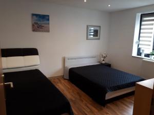a bedroom with two beds and a window at Bitscher str.70 in Zweibrücken