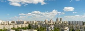 a view of a city with tall buildings at ARTAL Apartment on Obolonskaya Square 3 in Kyiv