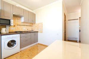 a kitchen with a washer and dryer at ARTAL Apartment on Obolonskaya Square 3 in Kyiv