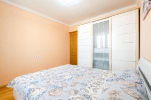 a bedroom with a bed and a glass door at ARTAL Apartment on Obolonskaya Square 3 in Kyiv
