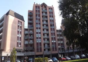 a tall building with cars parked in front of it at Airport Malpensa GALLARATE in Gallarate
