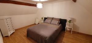 a bedroom with a large bed and a dresser at La Folie Hubert in Meung-sur-Loire +17 photos