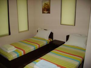 two beds sitting next to each other in a room at Panorama Complex in Tvŭrditsa