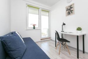 a living room with a couch and a table at Rooms4Less in Gdańsk