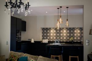 a kitchen with a table with chairs and a dining room at La Suite d'Elisabeth in Sarlat-la-Canéda