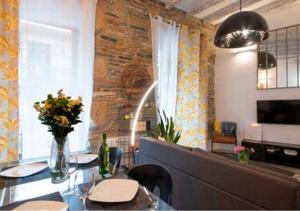 a dining room with a table with chairs and flowers at San Sebastián VERY NICE apartment 100m from La Kontxa Beach in San Sebastián