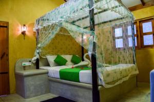 a bedroom with a bed with a canopy at Silver Shine Beach Resort in Kalpitiya