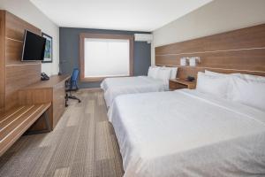 a hotel room with two beds and a flat screen tv at Holiday Inn Express Hotel & Suites San Diego Airport - Old Town, an IHG Hotel in San Diego