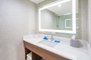 a bathroom with a sink and a mirror at Holiday Inn Express Hotel & Suites San Diego Airport - Old Town, an IHG Hotel in San Diego