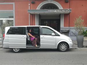 two people sitting in the back of a white van at Hotel Nuvò in Naples
