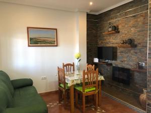 a living room with a table and chairs and a couch at Apartamento Triana l Bolonia, Tarifa in Bolonia