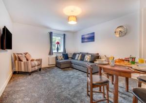 a living room with a couch and a table at Sunset View Apt 8 Skinningrove in Skinningrove