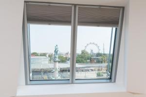 an open window with a view of a ferris wheel at Yourapartment Prater in Vienna
