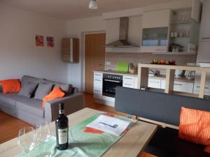 a living room with a bottle of wine on a table at Ferienhaus Bella Vista in Lake Pressegg