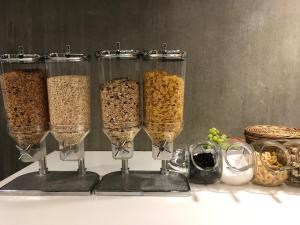 a group of four wine glasses filled with cereal at DBU Hotel & Kursuscenter in Aarhus