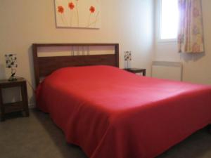 a bedroom with a large red bed with a window at 206 aix les bains in Aix-les-Bains