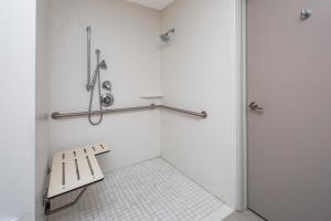 a bathroom with a bench and a shower at Holiday Inn Express Hotel & Suites San Diego Airport - Old Town, an IHG Hotel in San Diego