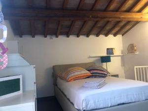 a bedroom with a bed in a room with wooden ceilings at Maison Elodie in Narni