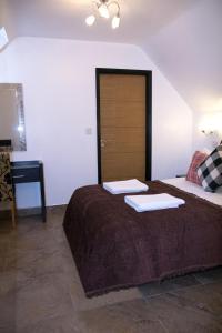 a bedroom with a bed and a desk at ATZ&H Inn in Bilston