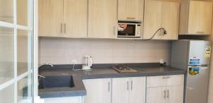 a kitchen with a sink and a microwave in it at Al Somow Chalets in Dahaban
