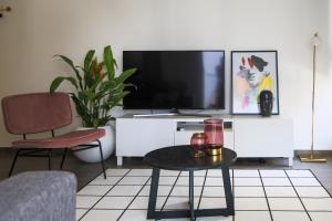 a living room with a tv and a table at Phaedrus Living City Centre Luxury Flat Anemone 103 in Nicosia